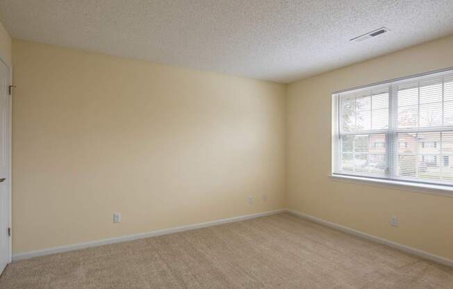 A room with a window and a door.
