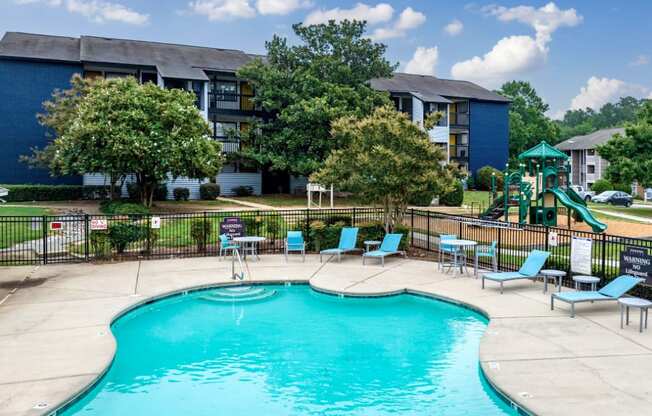 our apartments have a swimming pool with chairs and a playground