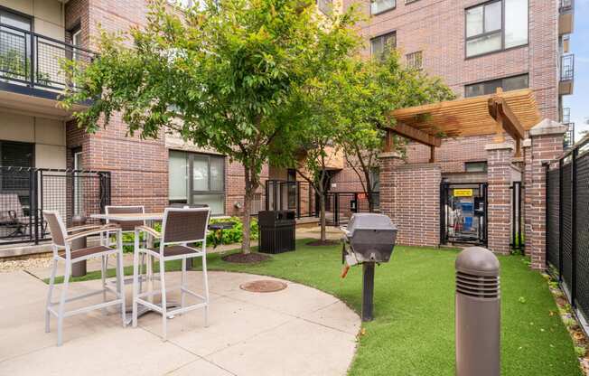 our apartments offer a patio with tables and chairs and a grill