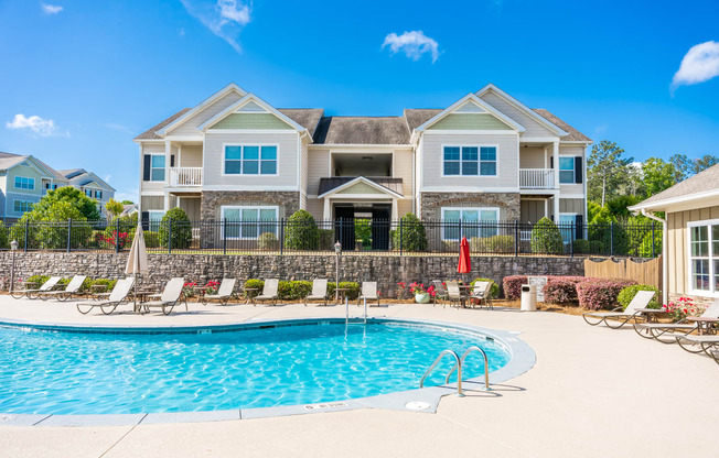 View of the outdoor sparkling swimming pool at Riverstone apartments for rent in Macon, GA