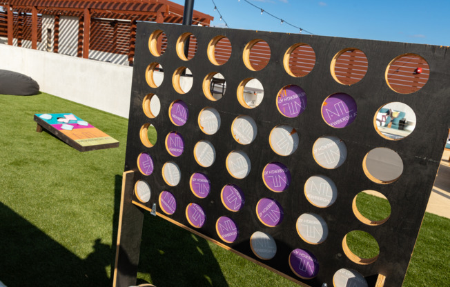 Roof lounge at our apartments for rent in Atlanta, featuring astroturf, connect four, and other games.