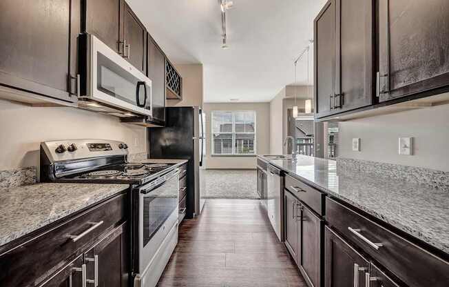 a kitchen with granite counter tops and wooden cabinets