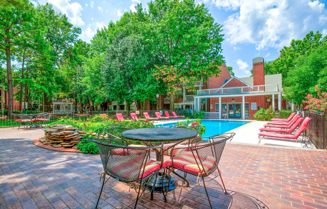 Sparkling pool with lounge chairs at Greenbriar Apartments in Tulsa, OK!