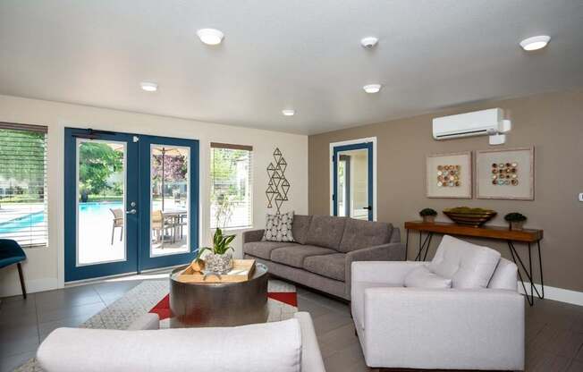 A living room with a white sofa, a grey couch, and a coffee table.