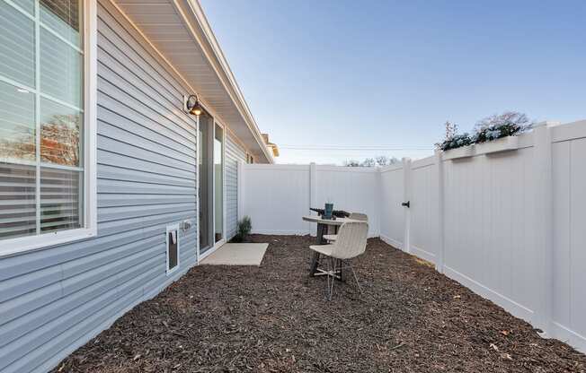 a single home fenced back yard with a small patio and furniture set at Sanctuary at Indian Creek