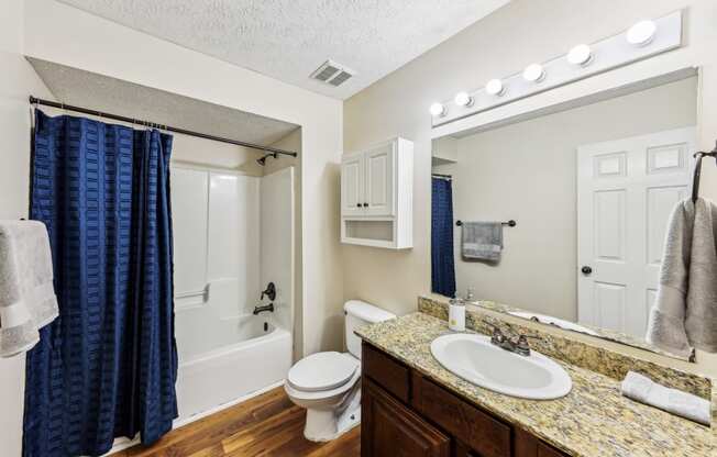 a bathroom with a tub and hardwood floor at Grand Reserve Columbus in Columbus, GA