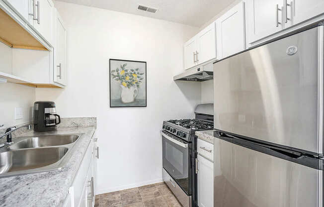 A kitchen with a stainless steel appliances at Newport Village Apartments, Portage, MI