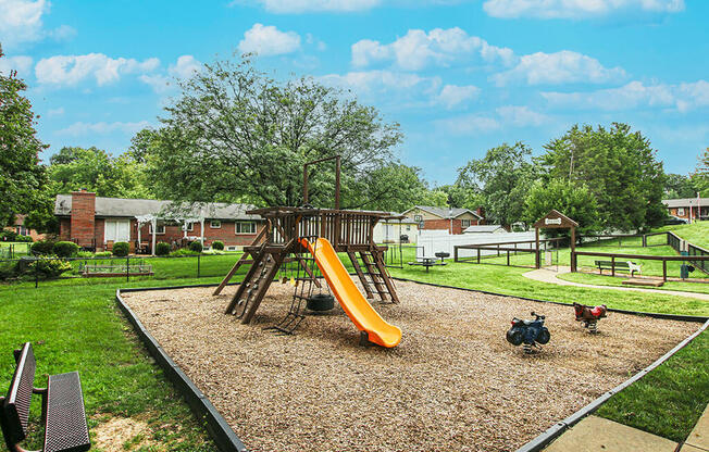 a playground with a swing set in a park