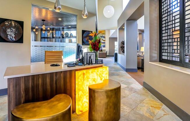 a hotel lobby with a bar and stools