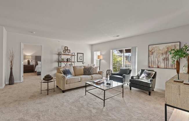 a living room with a couch and two chairs