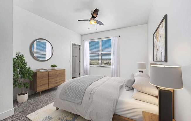 A bedroom with a bed, a ceiling fan, and a window with blinds at The Reserve at Destination Pointe apartments, Grimes, IA