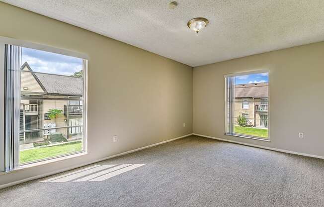 an empty living room with a large window