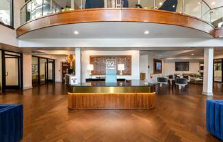 A reception area with a wooden floor and a reception desk.