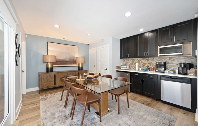 a kitchen and dining room with a table and chairs