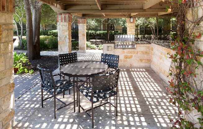 A patio with a table and chairs.