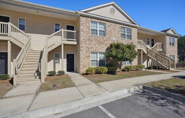 Apartment building with stairs and a sidewalk  at The Meadows, Bloomingdale, GA