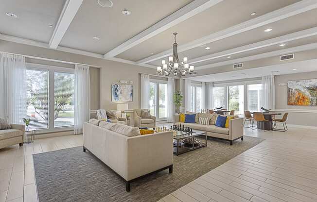 a large living room with couches and chairs and a chandelier