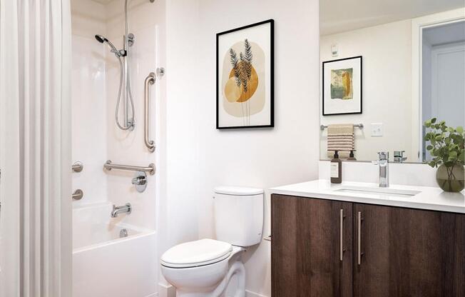 a bathroom with a toilet sink and shower and a mirror