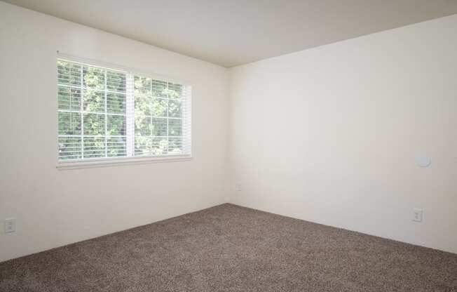 a small empty room with a large window
