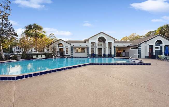 Community Swimming Pool with Pool Furniture at Vue at Baymeadows Apartments in Jacksonville, FL.