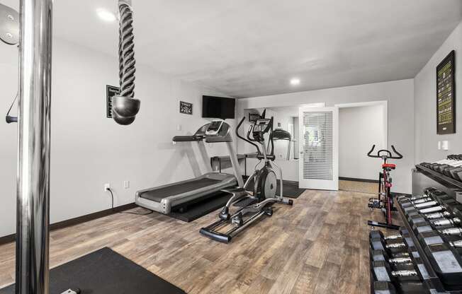 a home gym with a treadmill and weights at Mill Pond Apartments, Auburn, WA