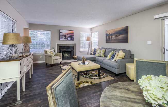 a living room with a couch table and chairs and a fireplace