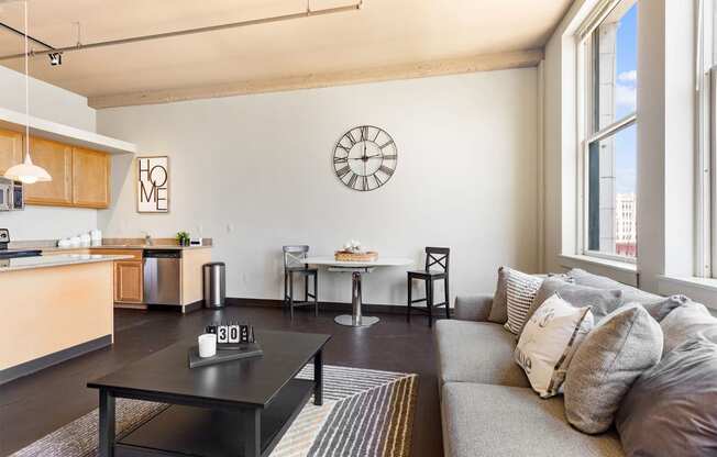 a living room with a couch and a clock on the wall