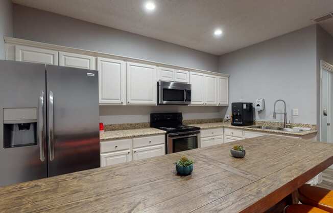 a kitchen with stainless steel appliances and a wooden table