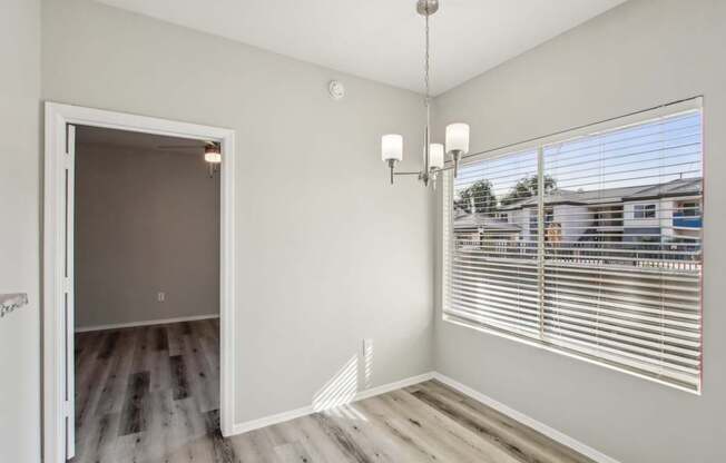A room with a white door and a chandelier.