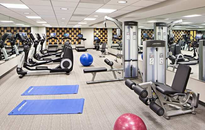 a gym with cardio equipment and weights in the new yorker hotel fitness center