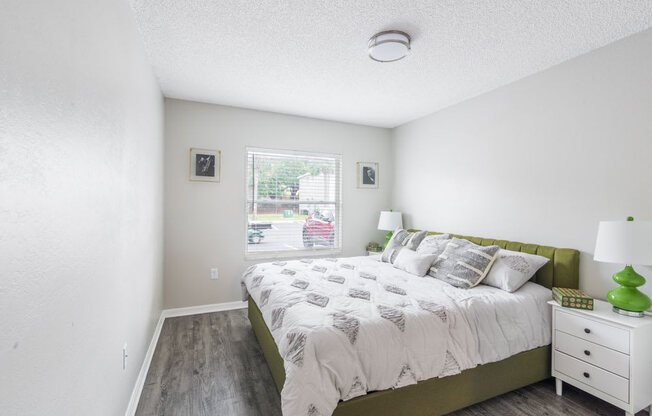 Bedroom with a bed and a window_Rolling Hills Apartments