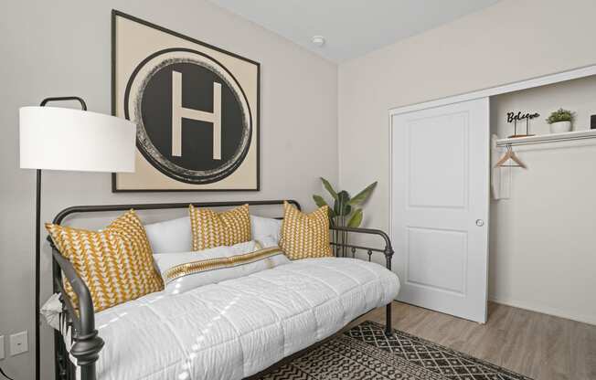 a white bedroom with a white bed and yellow pillows