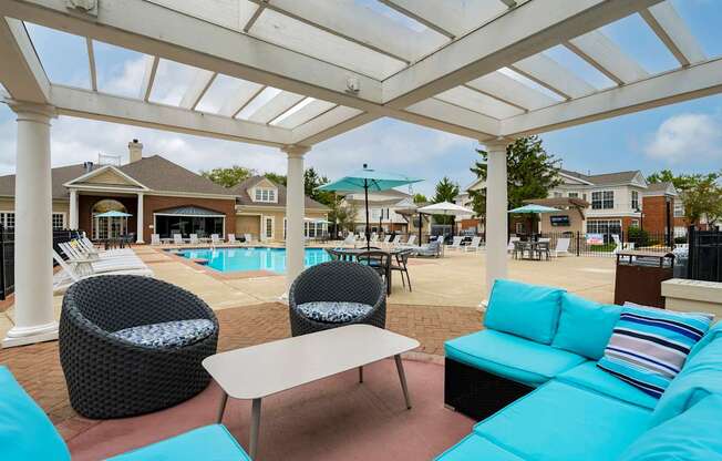 A white pergola over a patio with a pool in the background. at The Orchard, Dublin, Ohio