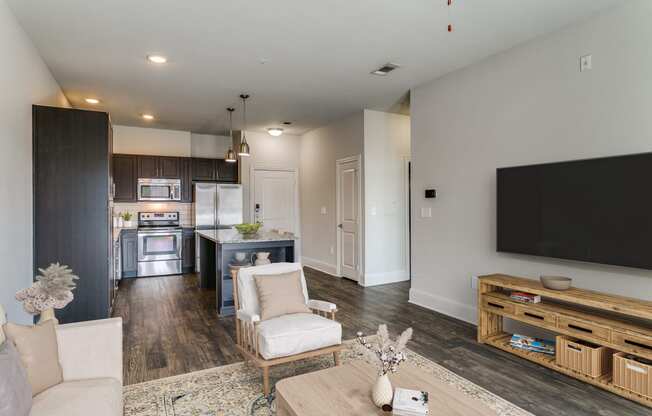 a living room with a tv and a kitchen