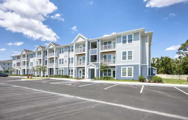 an empty parking lot in front of an apartment building