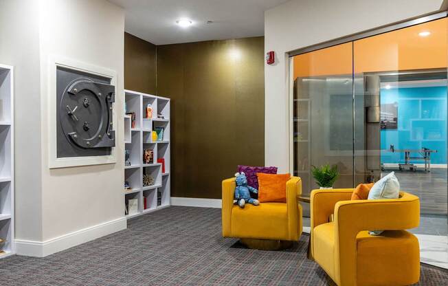a living room with yellow chairs and a television