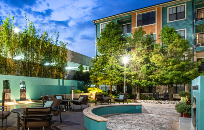 Gorgeous zen garden with foliage, seating, and waterfalls at Orlando apartments for rent