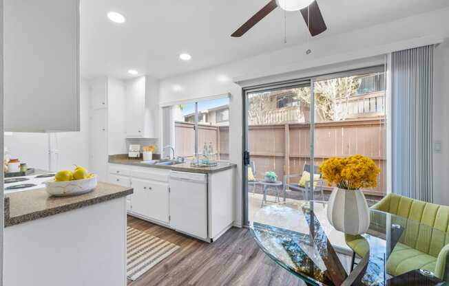 an open kitchen and dining area with a glass table and chairs