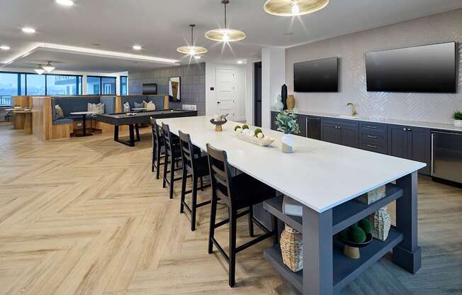 A modern kitchen with a long table and chairs.