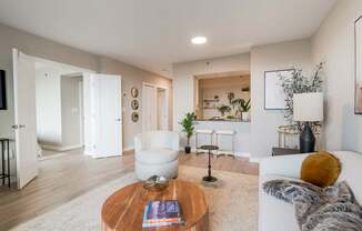 A modern living room with a white sofa and a coffee table.