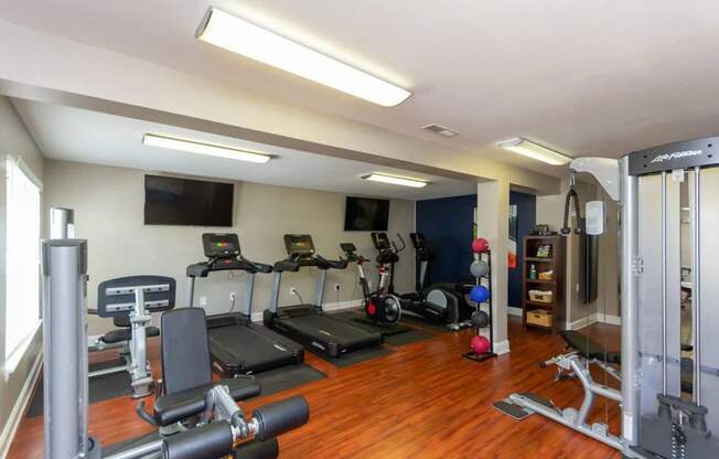 A well-equipped home gym with a variety of exercise machines.