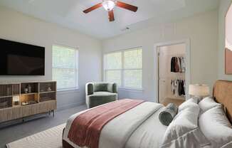 a bedroom with a large bed and a ceiling fan