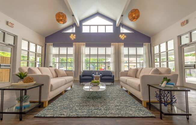 a living room with couches and chairs and a rug