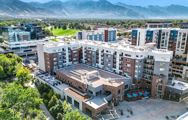 an aerial view of a large apartment complex with a golf course in the background