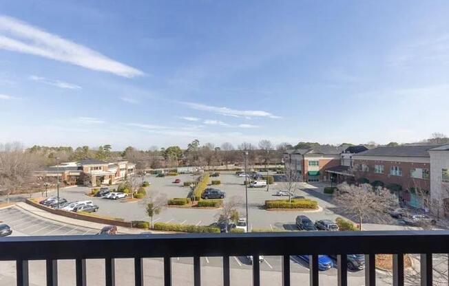 A parking lot with several cars and a building in the background.
