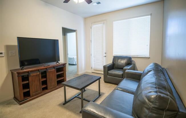 Living Room With Television at Four Seasons Apartments & Townhomes, North Logan, UT, 84341