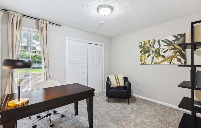 an office with a desk and a chair and a window