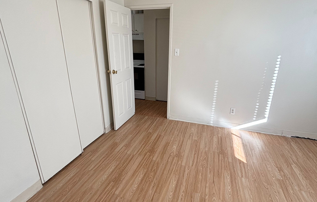 Inviting room with elegant wooden flooring and ample natural light, perfect for a cozy and modern living space.