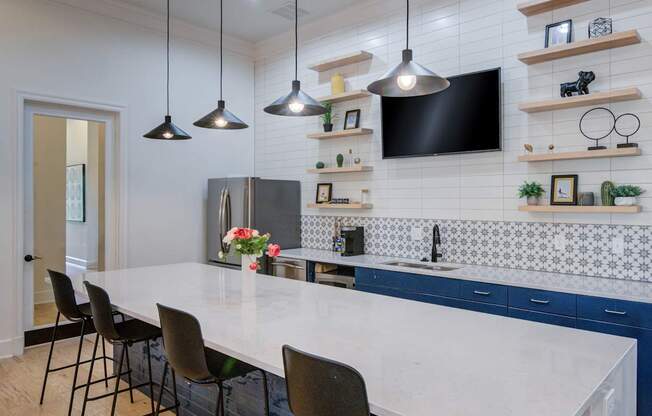 A kitchen with a white countertop and blue cabinets.