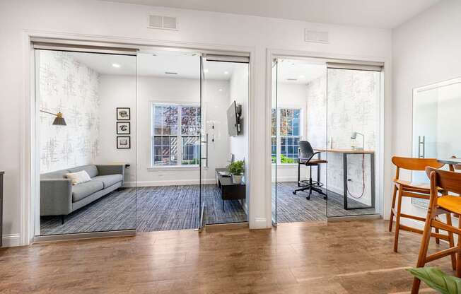A living room with a grey couch and a wooden chair.